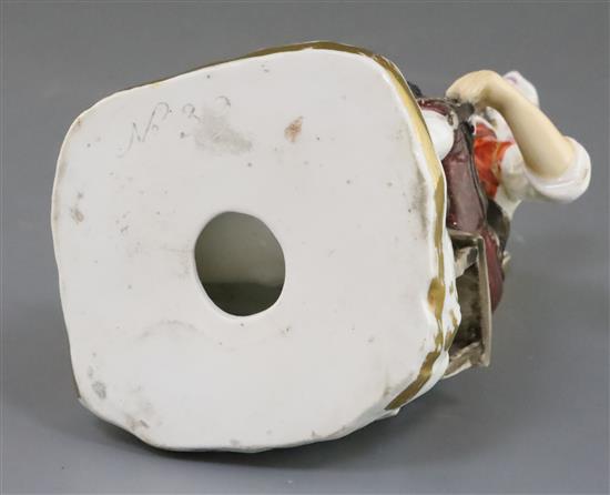 A Rockingham porcelain figure of a seated cobbler, c.1830, H.14cm, left arm re-stuck at shoulder